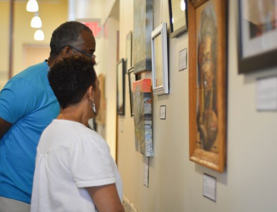 adults view hanging art