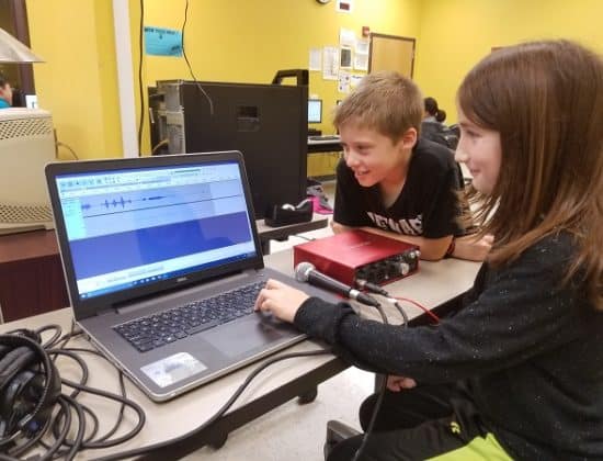 Students looking at sound waves on computer in radio club